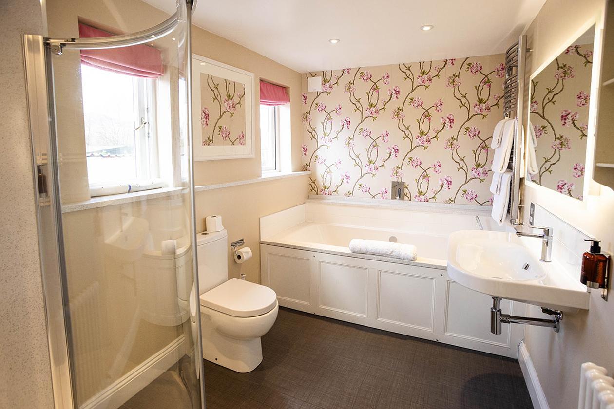Main bathroom with bath and shower
