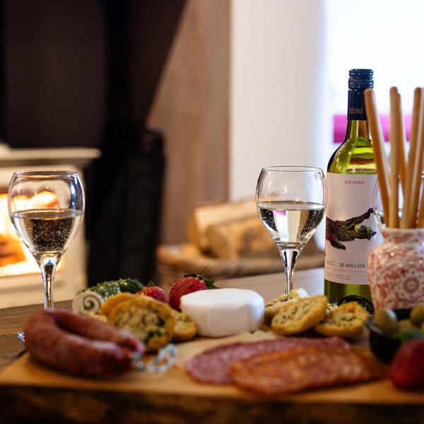 Charcuterie platter and wine set in front of a roaring log fire (for illustration only, not included)